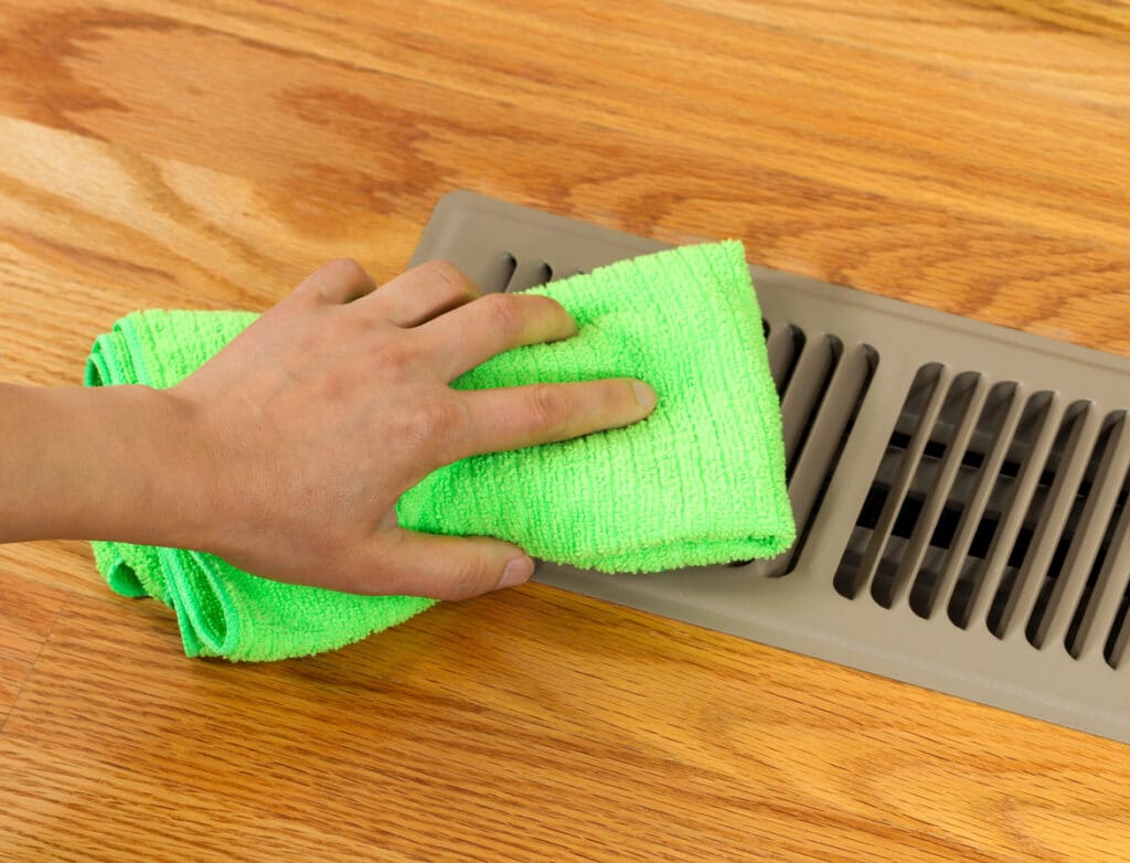 hand cleaning heater floor vent